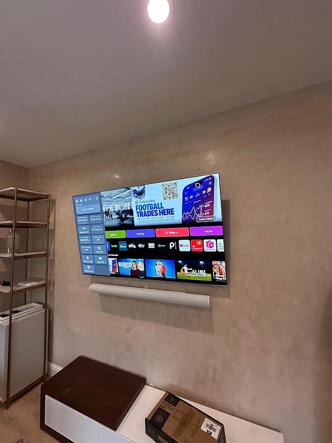 Wall-mounted television and soundbar installed in a living room